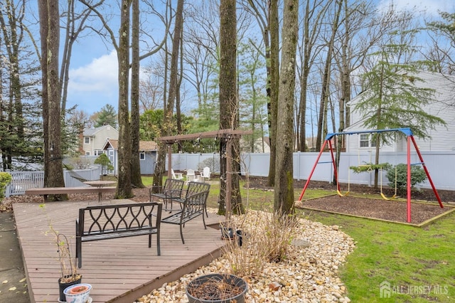 exterior space with a fenced backyard and a playground