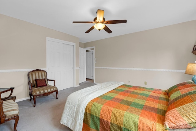 bedroom featuring ceiling fan, carpet flooring, a closet, and baseboards