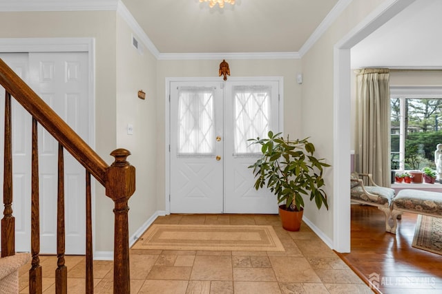 foyer entrance with french doors, ornamental molding, visible vents, stairway, and baseboards