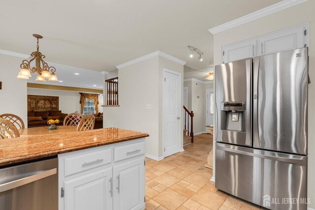 kitchen with white cabinets, stainless steel appliances, and ornamental molding
