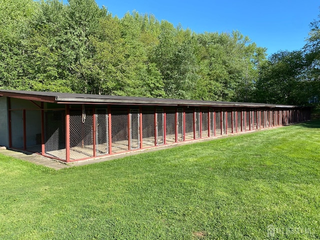 rear view of property with a yard and an outdoor structure