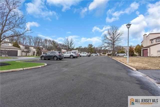 view of street featuring a residential view, curbs, and street lighting