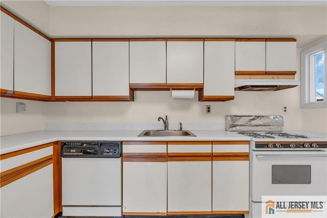 kitchen with under cabinet range hood, a sink, white appliances, white cabinets, and light countertops