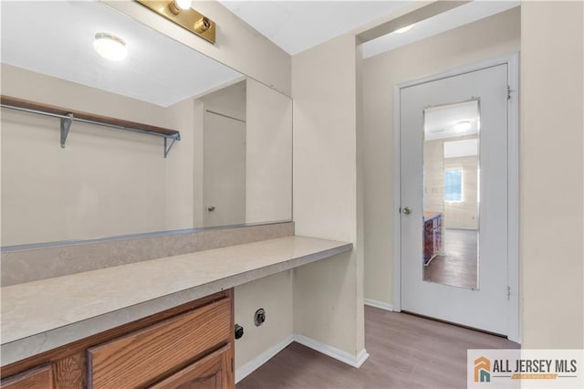 washroom featuring light wood-type flooring and baseboards