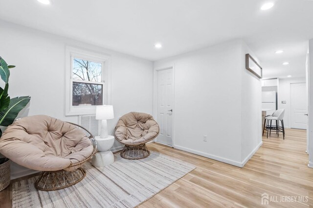 sitting room with light hardwood / wood-style floors