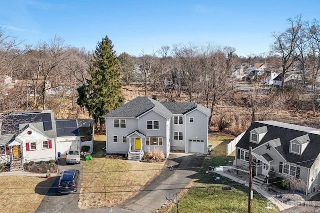 view of front of home with a garage and a residential view