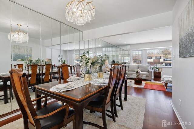 dining room featuring dark wood-type flooring and a chandelier