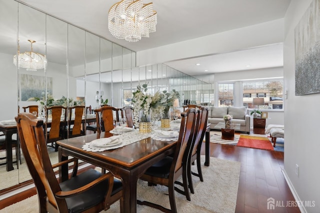 dining room with an inviting chandelier and dark hardwood / wood-style floors