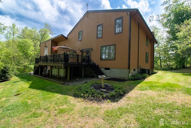 rear view of property featuring stairs, a deck, a yard, and central AC unit