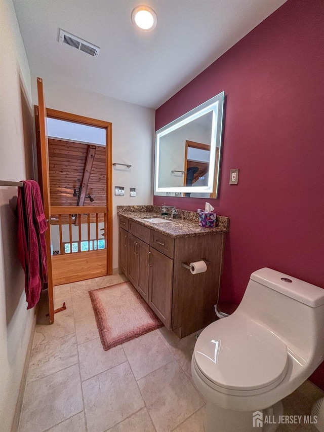 half bathroom featuring toilet and vanity