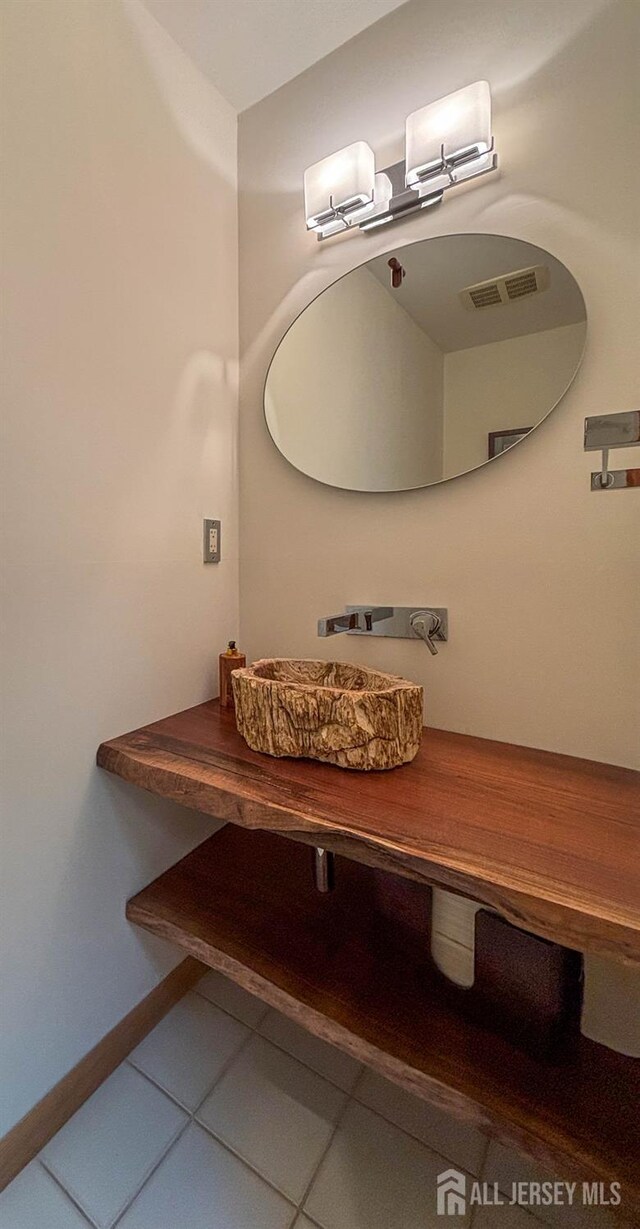 bathroom featuring tile patterned floors and baseboards