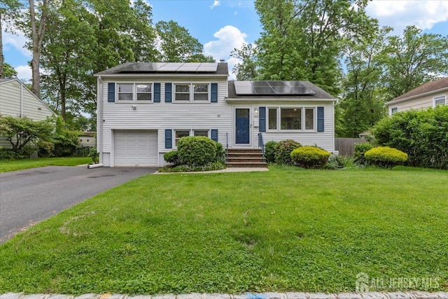 606 Hayward St, Bound Brook, NJ 08805 - tri-level home with an attached garage, a front yard, driveway, and solar panels