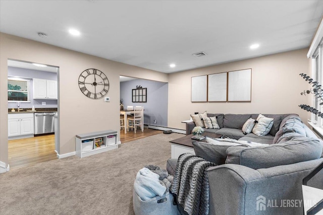 606 Hayward St, Bound Brook, NJ 08805 - living area featuring a baseboard radiator, light carpet, and recessed lighting
