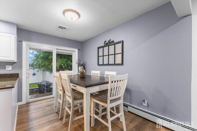 606 Hayward St, Bound Brook, NJ 08805 - dining room with a baseboard heating unit and wood finished floors