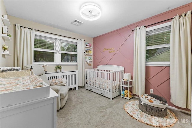606 Hayward St, Bound Brook, NJ 08805 - bedroom with a nursery area, light colored carpet, and a decorative wall