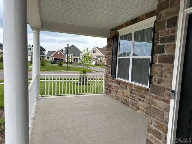 view of patio with covered porch and a residential view