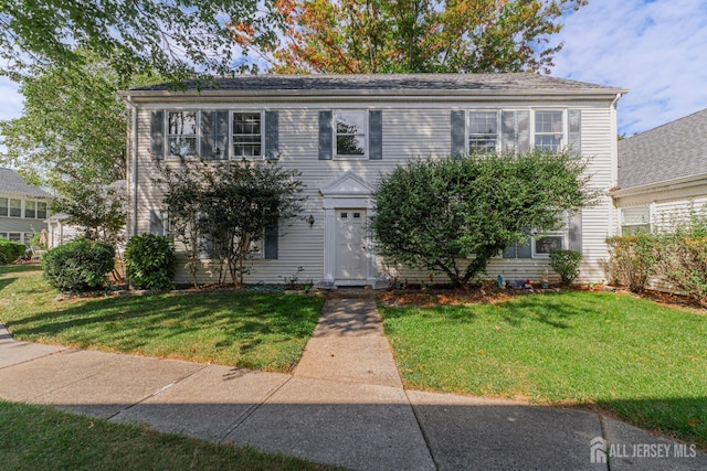 colonial inspired home with a front yard