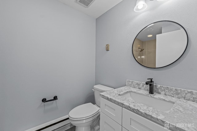 bathroom featuring a baseboard heating unit, toilet, visible vents, and vanity