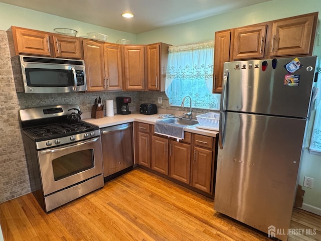 64 Bender Ave, Iselin, NJ 08830 - kitchen featuring stainless steel appliances, light wood-type flooring, light countertops, tasteful backsplash, and recessed lighting