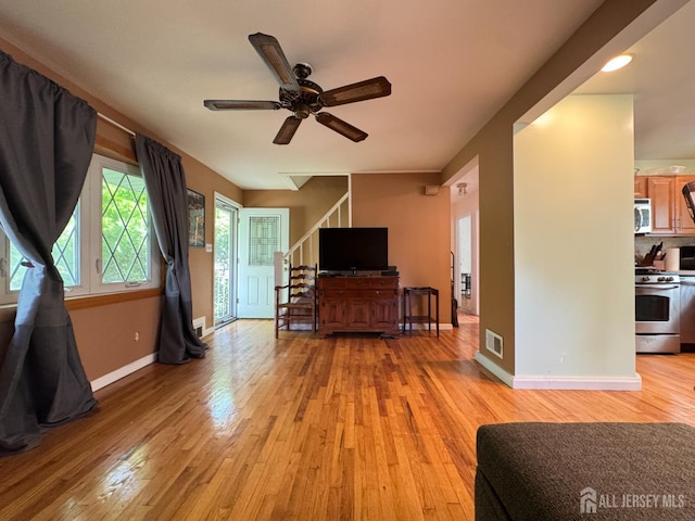 64 Bender Ave, Iselin, NJ 08830 - living room with a ceiling fan, light wood finished floors, and stairs