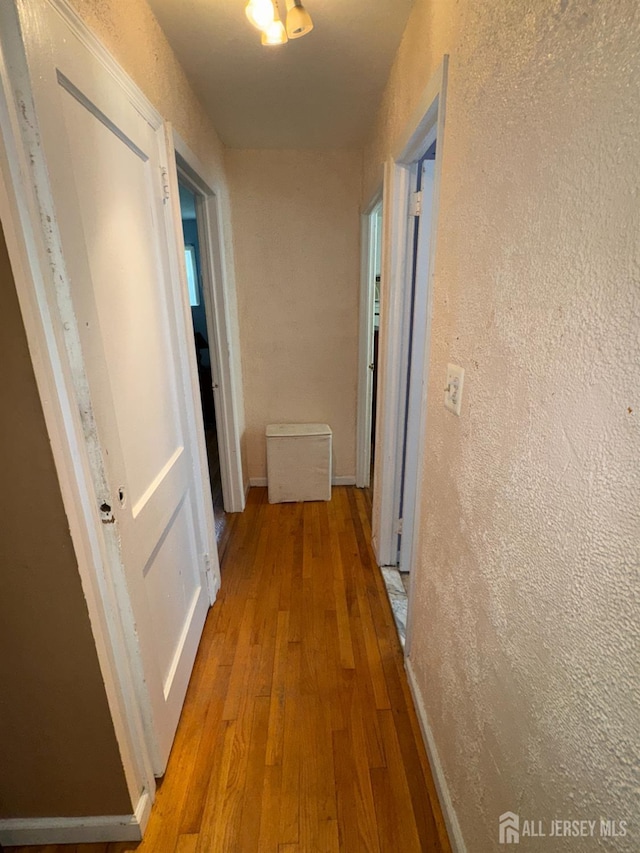 64 Bender Ave, Iselin, NJ 08830 - hall with light wood-style flooring and a textured wall