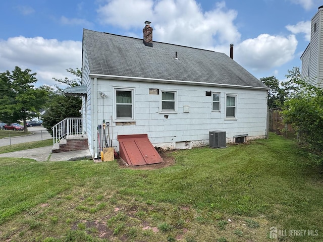 64 Bender Ave, Iselin, NJ 08830 - rear view of property with a shingled roof and a chimney