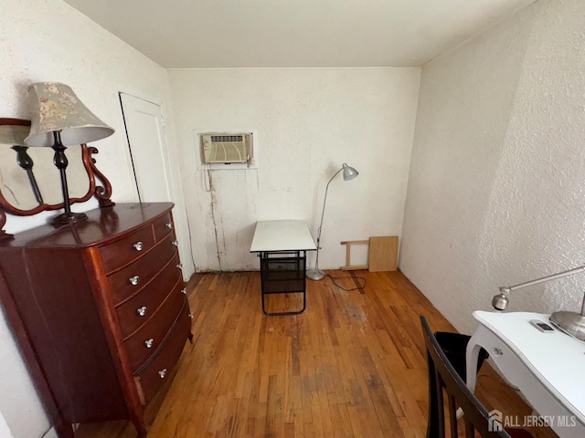 64 Bender Ave, Iselin, NJ 08830 - bedroom featuring a wall unit AC, light wood finished floors, and a textured wall
