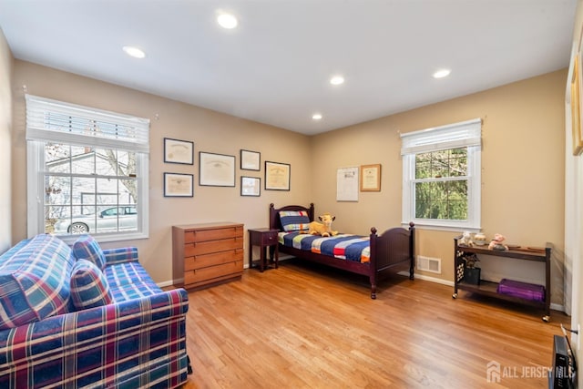 bedroom with baseboards, visible vents, wood finished floors, and recessed lighting