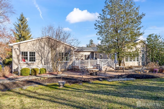 back of house featuring a yard and a patio area