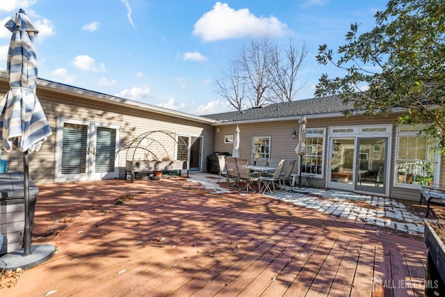 exterior space with outdoor dining area and a wooden deck