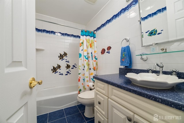 bathroom featuring tile walls, shower / bathtub combination with curtain, toilet, vanity, and tile patterned flooring