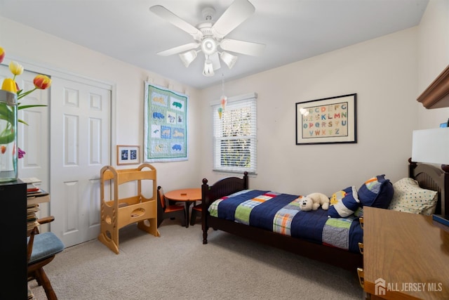 bedroom with carpet floors, a closet, and a ceiling fan