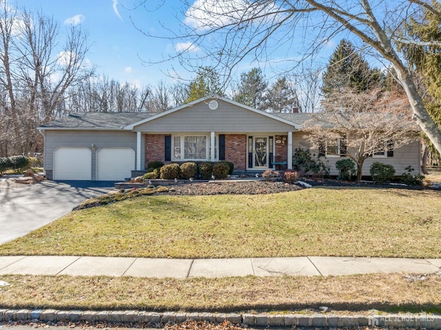 ranch-style house featuring a garage, brick siding, driveway, a front lawn, and a chimney