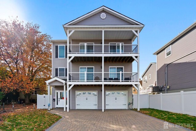 view of front of house with central AC unit and a garage