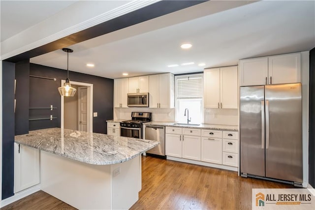 4 Woodrow St, Middlesex, NJ 08846 - kitchen with stainless steel appliances, white cabinets, wood finished floors, and recessed lighting