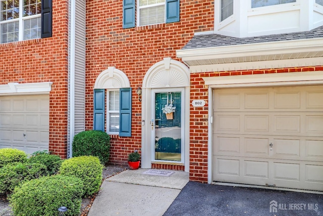 802 Carnaby Ln, Toms River, NJ 08753 - property entrance with brick siding, driveway, and roof with shingles
