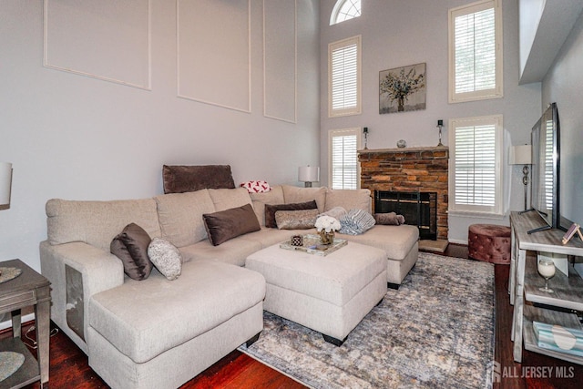 802 Carnaby Ln, Toms River, NJ 08753 - living room with a towering ceiling, dark wood-style floors, healthy amount of natural light, and a stone fireplace