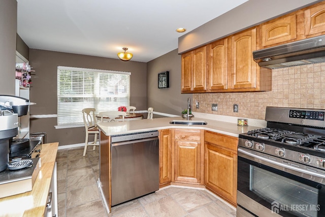 802 Carnaby Ln, Toms River, NJ 08753 - kitchen featuring stainless steel appliances, under cabinet range hood, a peninsula, decorative backsplash, and light countertops