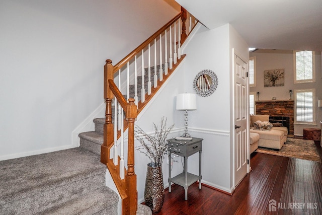 802 Carnaby Ln, Toms River, NJ 08753 - stairs featuring hardwood / wood-style floors and a fireplace