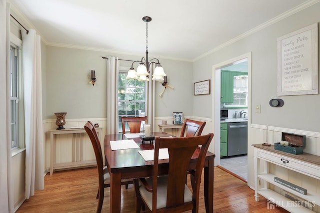 70 Surrey Ln, Woodbridge Proper, NJ 07067 - dining room featuring a chandelier, wainscoting, ornamental molding, light wood-style flooring, and radiator