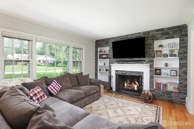 70 Surrey Ln, Woodbridge Proper, NJ 07067 - living room with crown molding, wood finished floors, a fireplace, and built in shelves