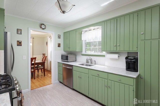 70 Surrey Ln, Woodbridge Proper, NJ 07067 - kitchen featuring light countertops, stainless steel appliances, light wood-style flooring, crown molding, and tasteful backsplash