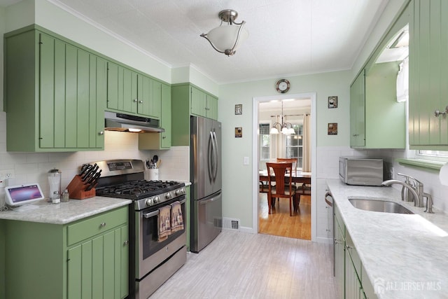 70 Surrey Ln, Woodbridge Proper, NJ 07067 - kitchen featuring stainless steel appliances, green cabinetry, light countertops, light wood-type flooring, and under cabinet range hood