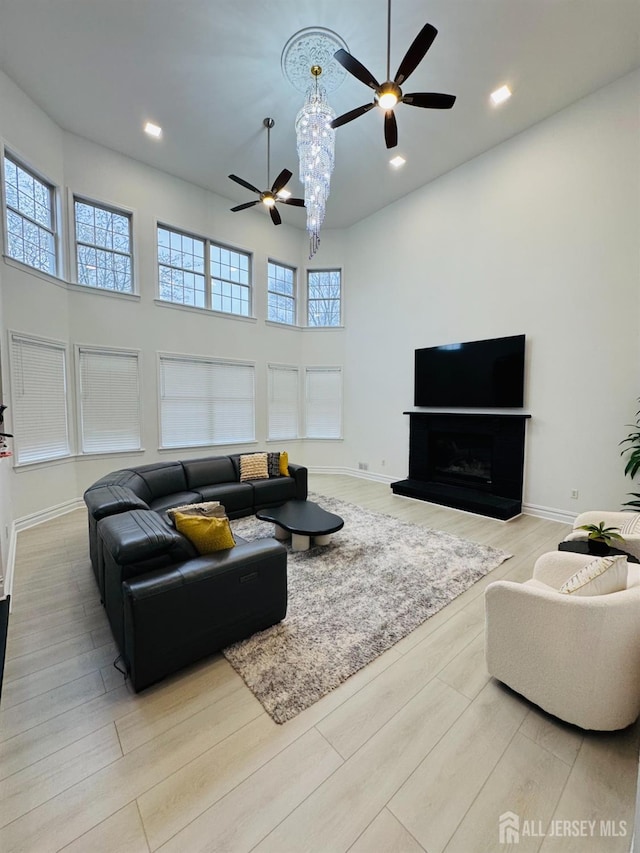 35 NE Bennett Rd, Old Bridge, NJ 07747 - living room featuring plenty of natural light, ceiling fan, a towering ceiling, and wood finished floors