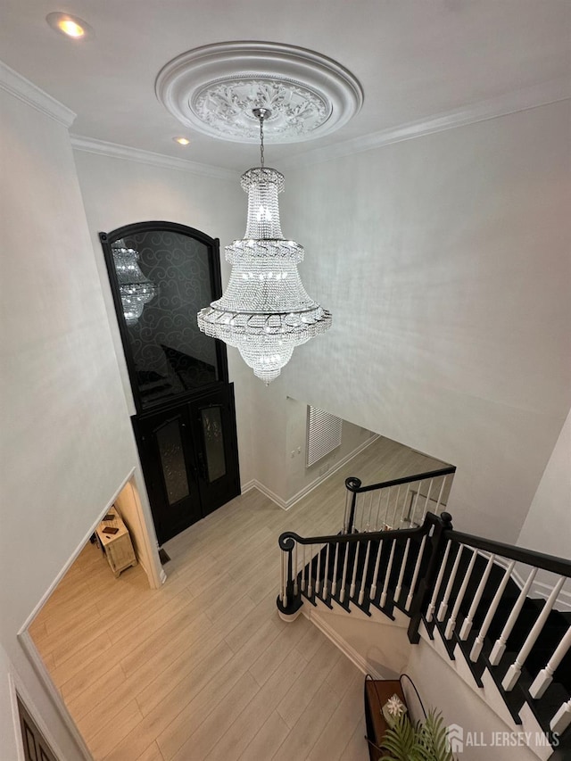 35 NE Bennett Rd, Old Bridge, NJ 07747 - staircase featuring recessed lighting, crown molding, wood finished floors, and a notable chandelier
