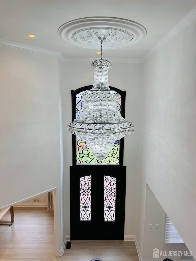 35 NE Bennett Rd, Old Bridge, NJ 07747 - entrance foyer featuring baseboards, a notable chandelier, crown molding, and a high ceiling