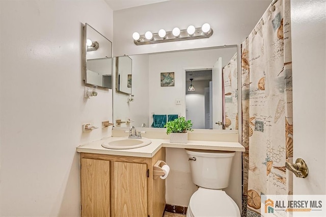 bathroom featuring vanity and toilet