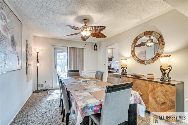 carpeted dining space featuring ceiling fan and a textured ceiling