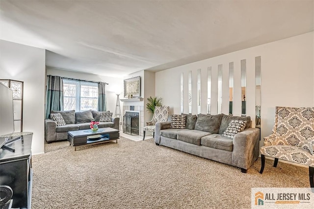 living room with a fireplace and carpet