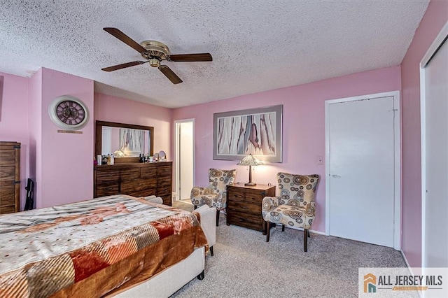 carpeted bedroom with a textured ceiling and ceiling fan